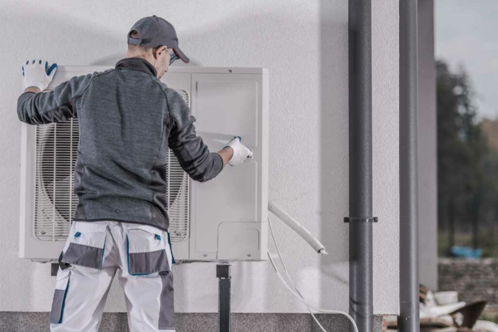 Technician performing a heat pump installation.