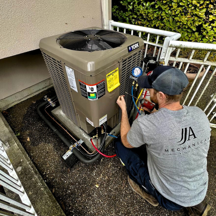 JJ&A Mechanical's Vancouver plumber installing an HVAC system